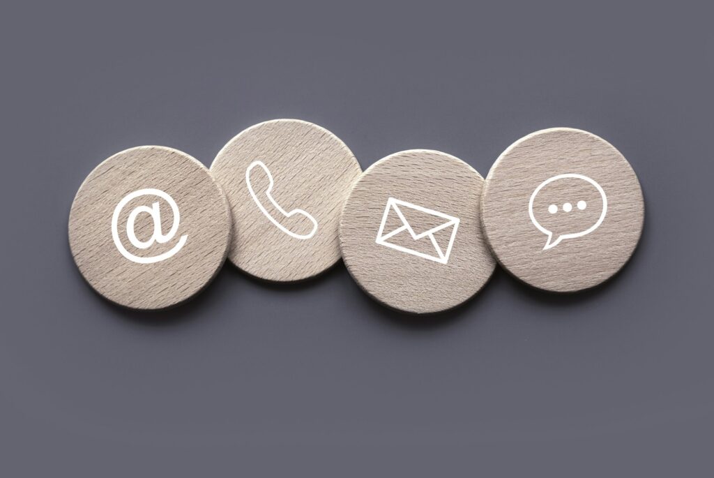 Icon of communication type on wooden circle. Contact us or Customer support hotline people connect.